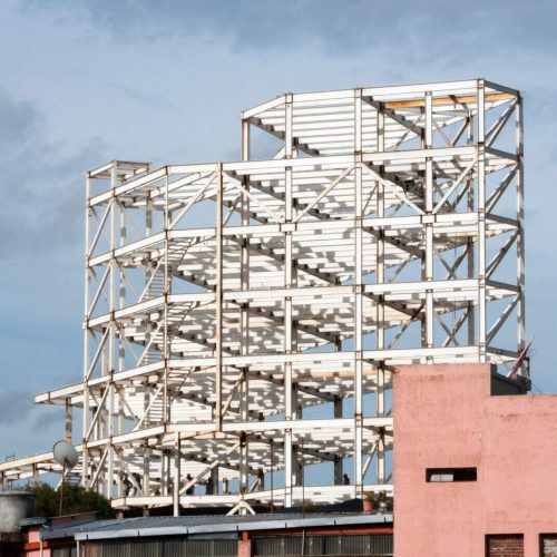 Construction of a steel-based building in Guatemala City at sunrise
