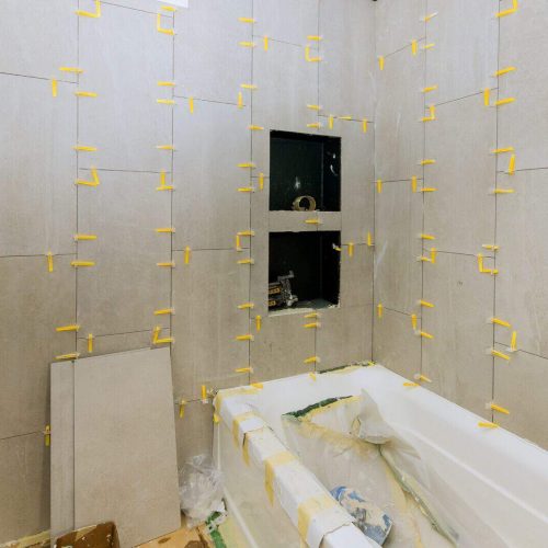 Construction work installing ceramic tile on reconstruction of bathroom during or renovation