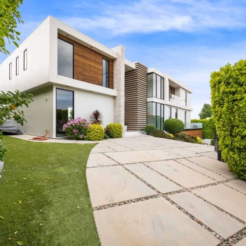 Driveway of a contemporary house with a garden area