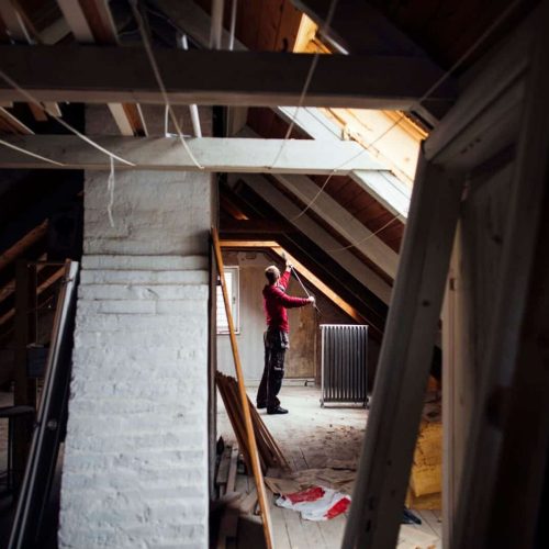 Person renovating an attic space