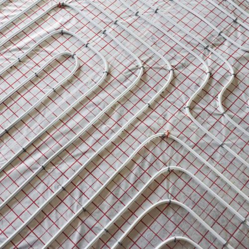 Pipes of underfloor heating system. Close up view. No people