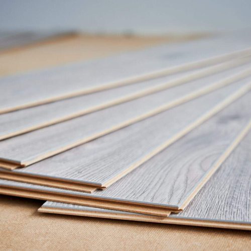 Samples of laminate timber planks on the floor.