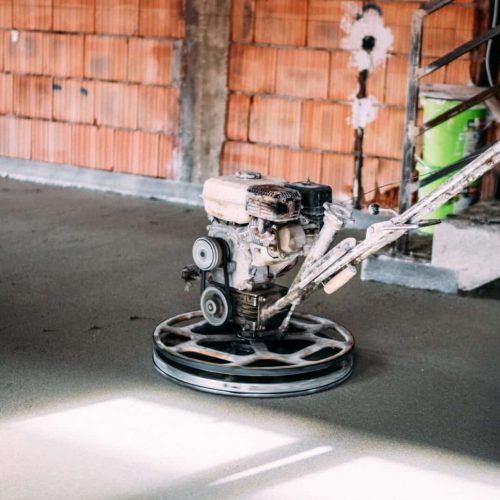 Screed smoothing at new house construction site