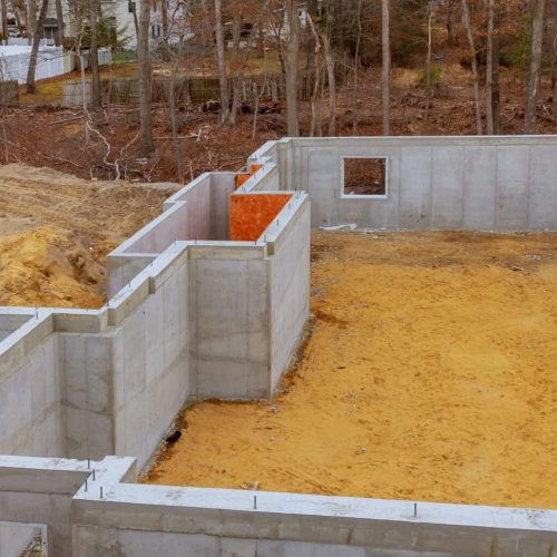 Under construction foundation new home with cement basement foundation